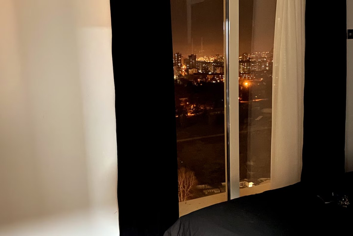 Bedroom 2 in the evening with warm lighting